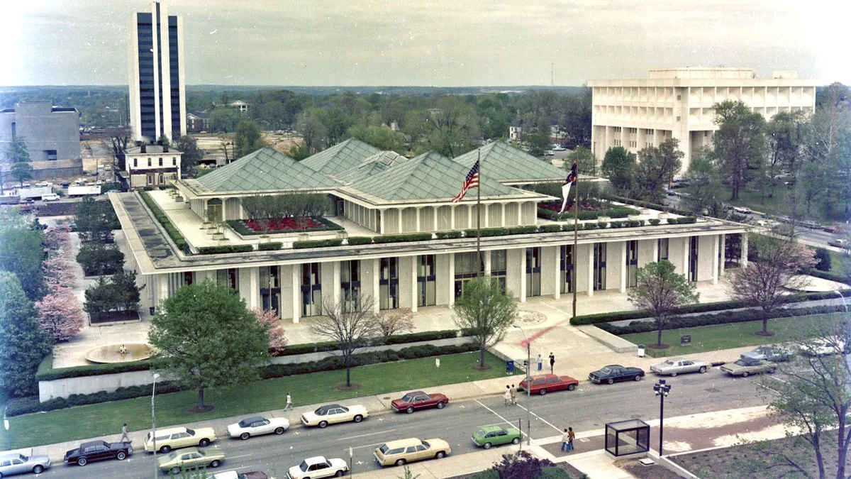 An elevated view of the North Carolina State Legislative Building in Raleigh in 1977, showing its copper pyramid roofs, rooftop gardens and Jones Street in front